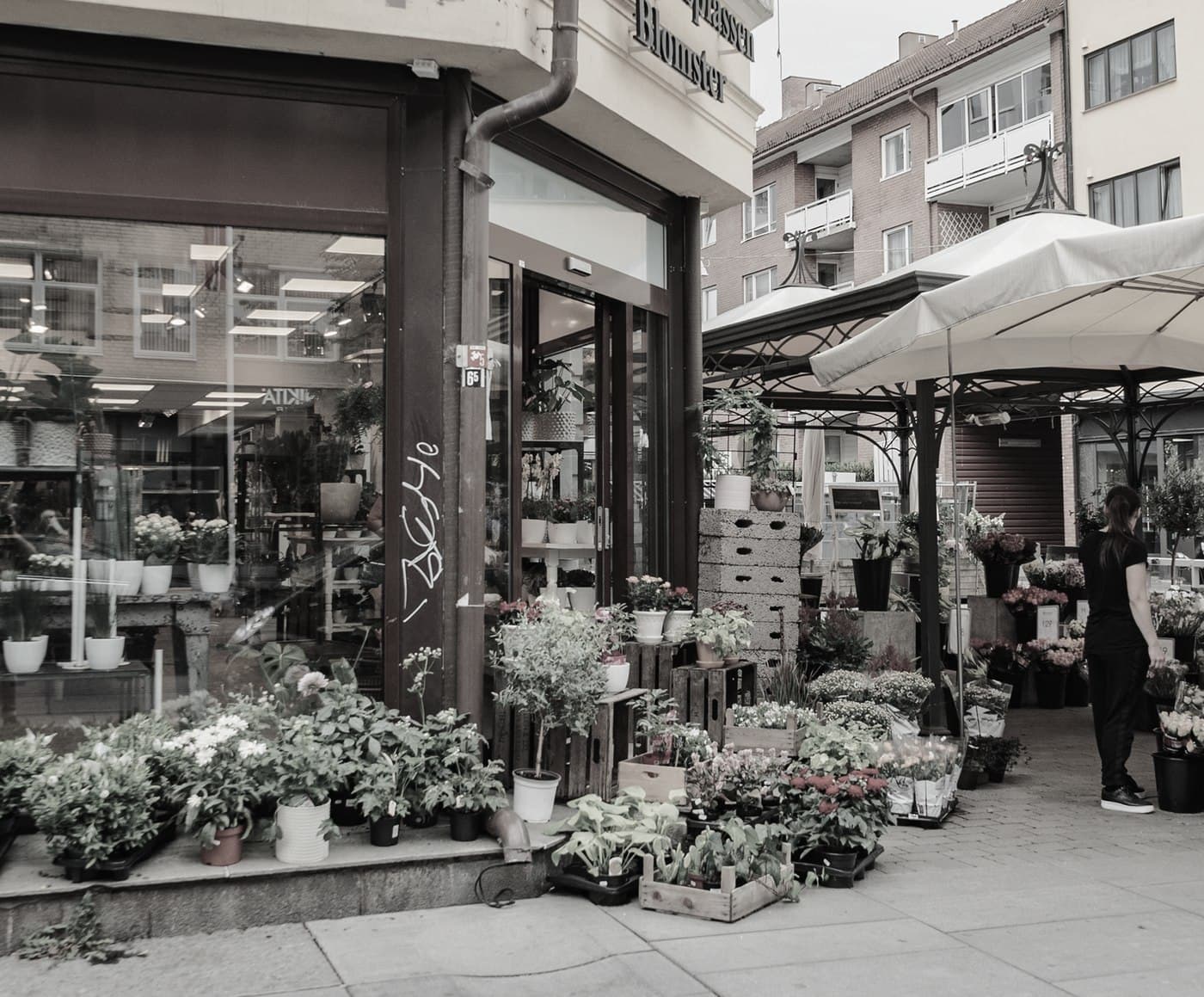 A florist's corner shop with market umbrellas
